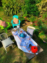 Load image into Gallery viewer, Carrageen Dream Table Runner in orange and beige on a sky blue  background on 100% Irish Linen. 140cm x 40cm. Designbybell.ie